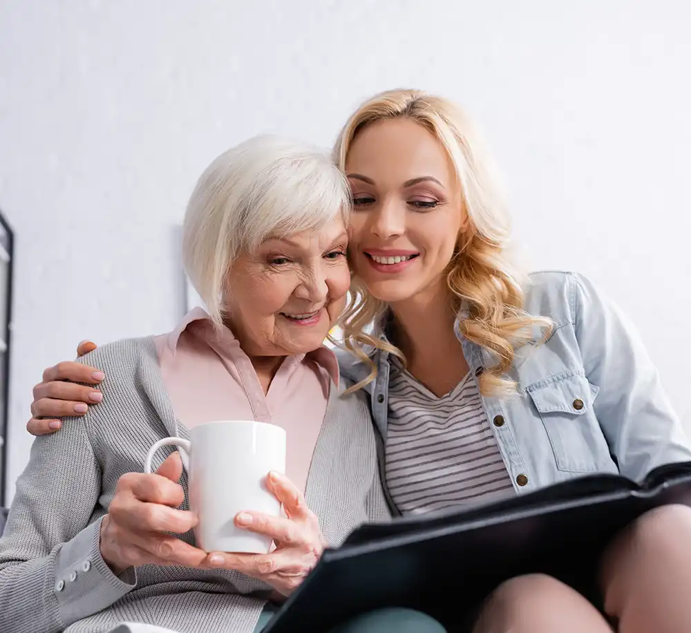 Woman looking at a photo book with her mother